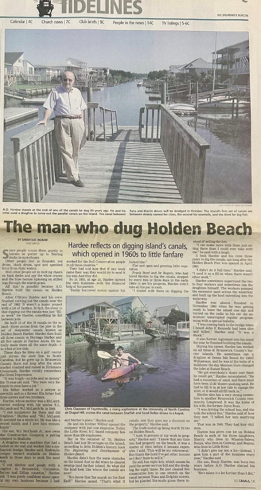 Article shows man on dock, kayakers, and canal’s history.