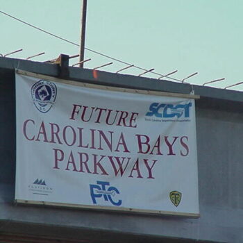 Banner reads Future Carolina Bays Parkway with logos.
