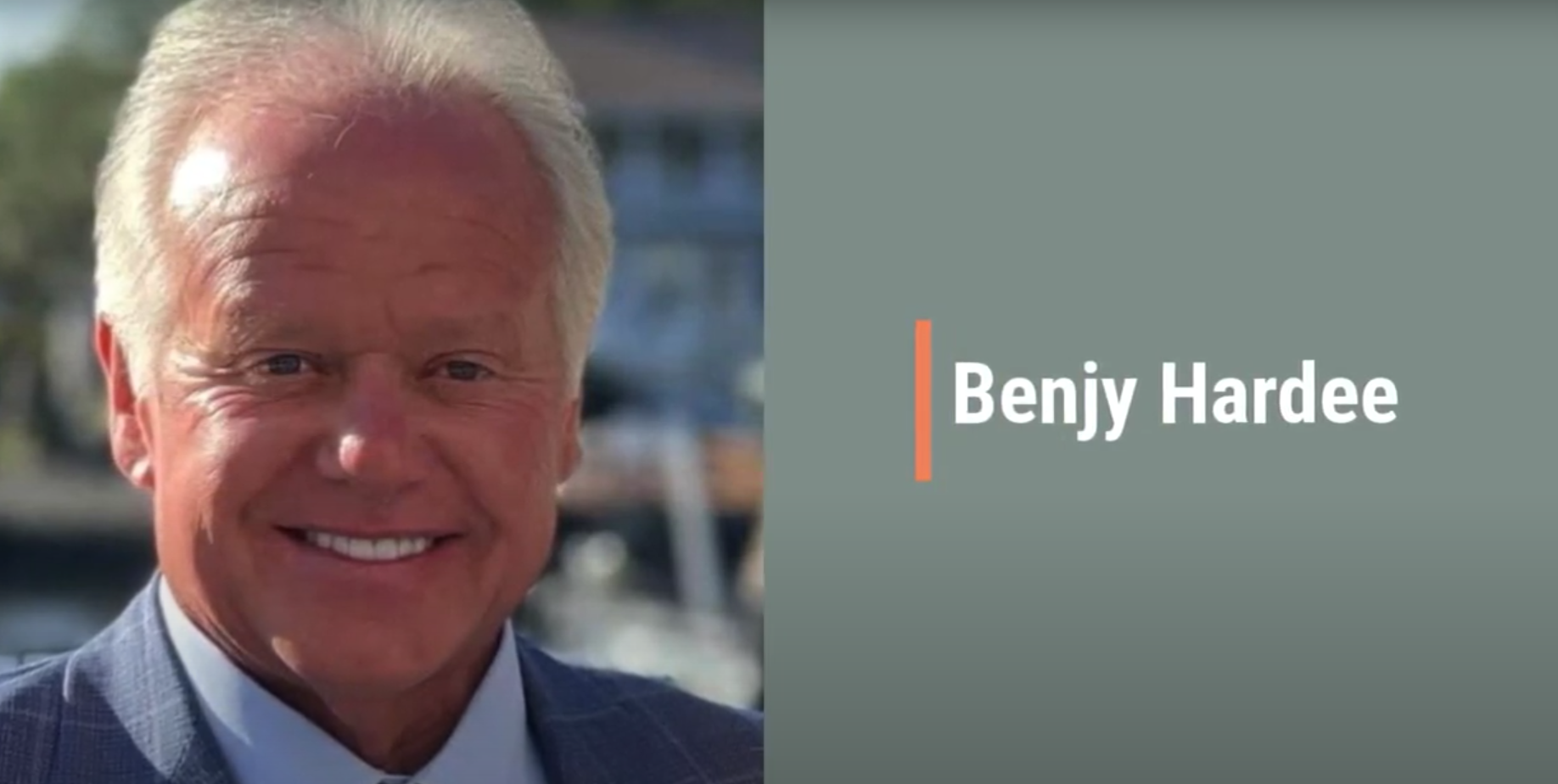 Smiling man in suit beside Benjy Hardee text.